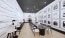 large seating area with table and photographers on the wall