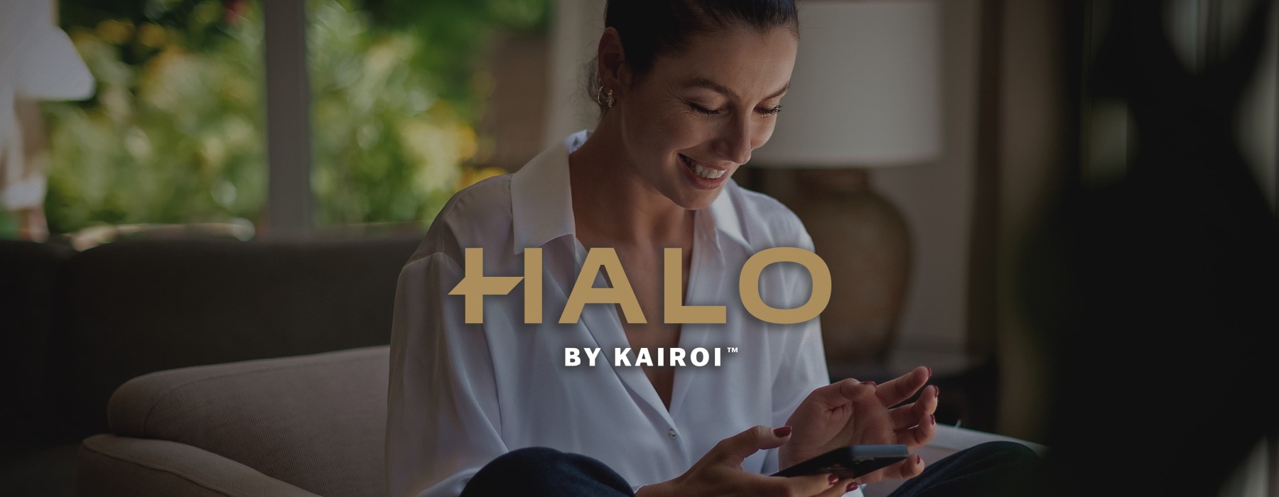 a woman smiling and interacting with her device