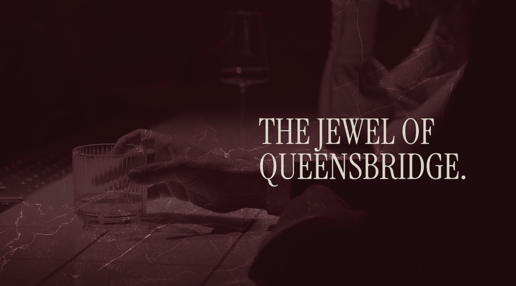 The Jewel of Queensbridge. a person holding a drink