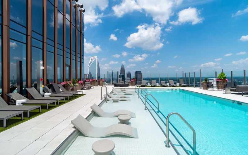 rooftop pool with seating next to building