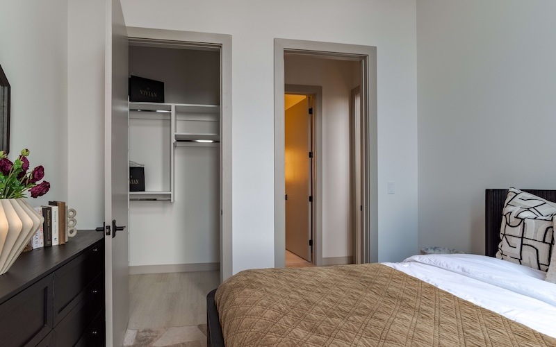 closet next to bathroom with bed