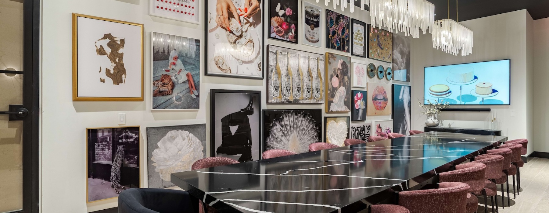 a private dining area with a long table and a wall with many pictures