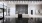 a room with a large glass wall and a black and white floor