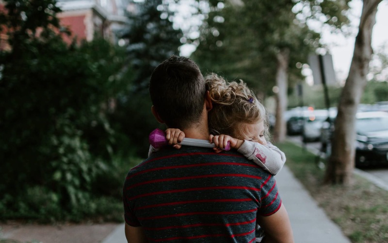 a man holding a girl